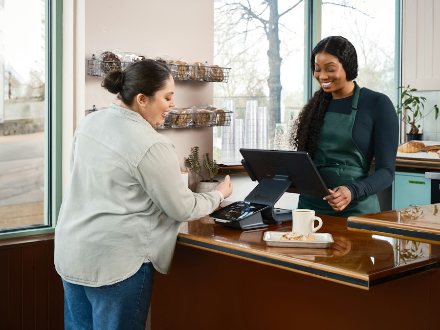 A café owner helping a customer at the counter